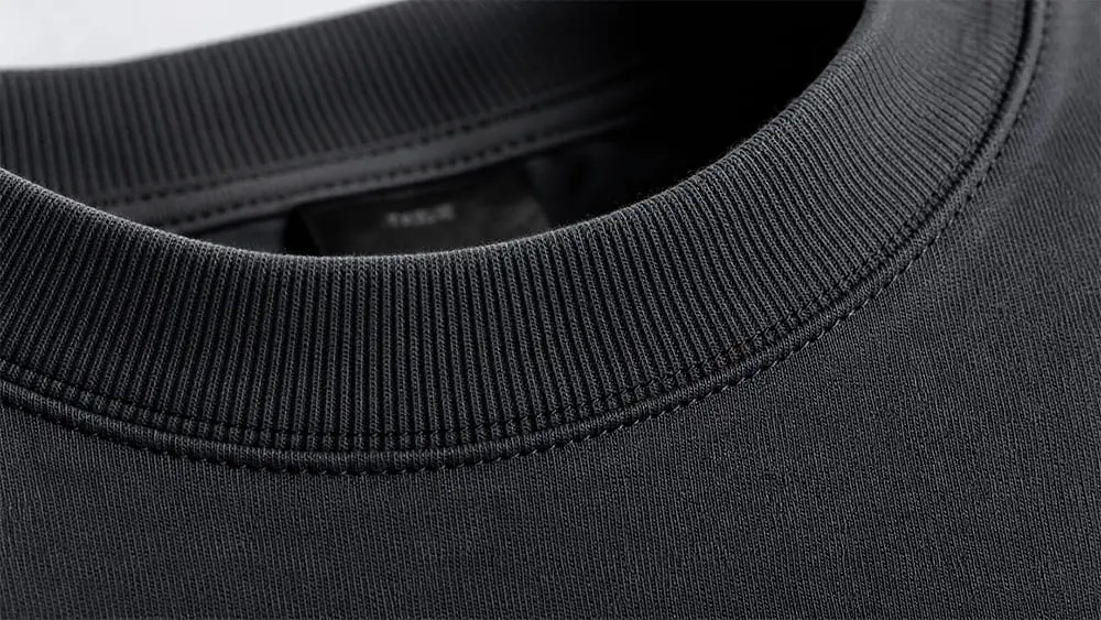 Close-up of thick rib collar with double needle stitching.